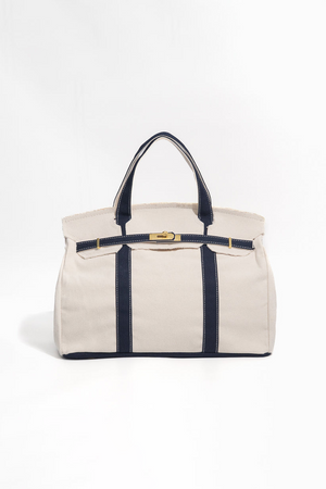 Beige handbag with navy accents on a white background