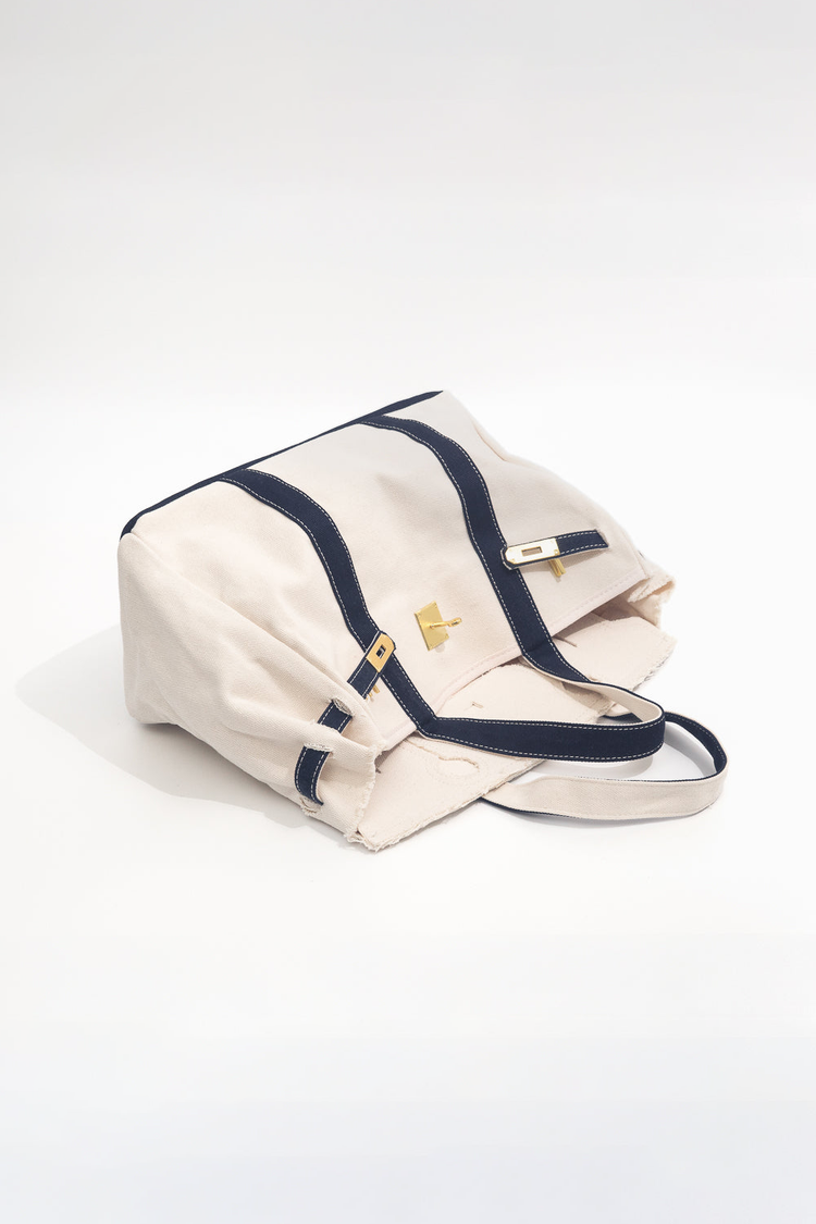 Beige bag with navy straps on a white background