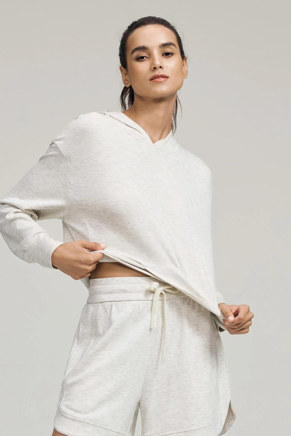 Emara women’s Heather Mist Crossover Hem Hoodie, relaxed fit Tencel™ knit on model